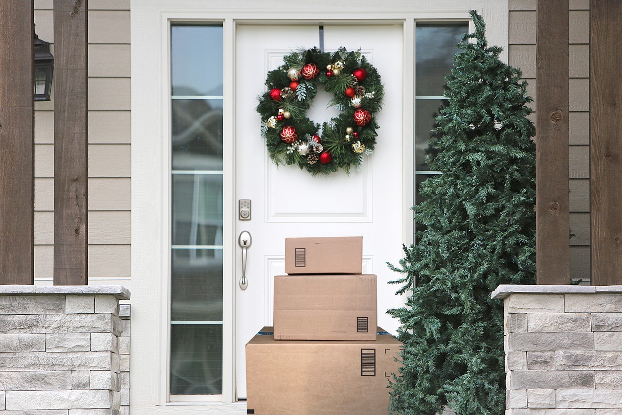 front door with Christmas wreath and packages