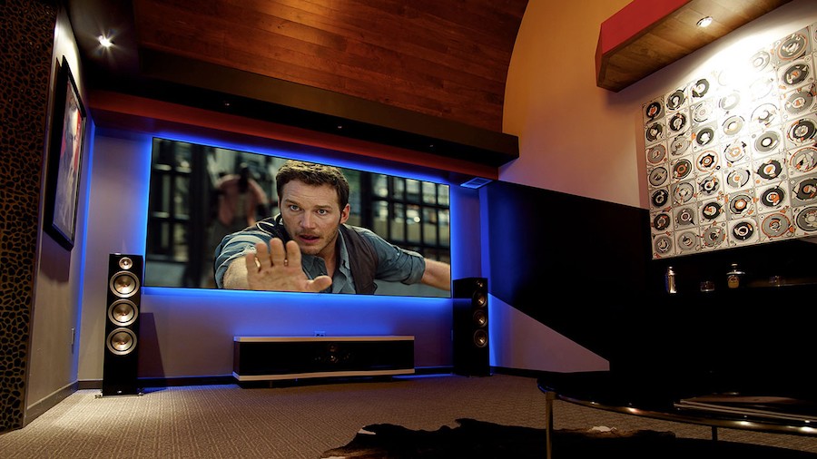 high-end home cinema screen with a Chris Pratt movie scene on the big screen back-lit in blue