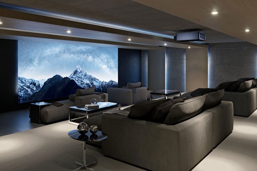 A home theater with a Sony projector, large movie screen, and chaise lounges.